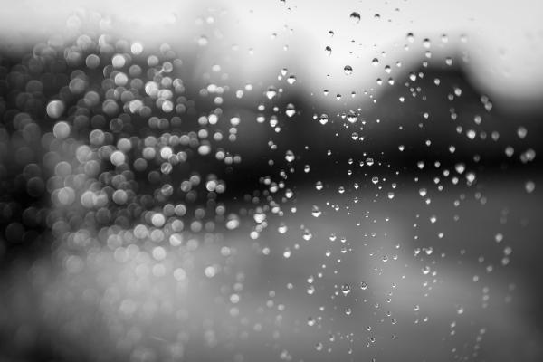 raindrops on a window with a dark background